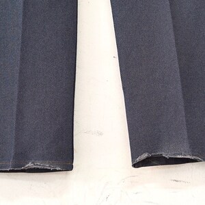 May include: A pair of dark blue denim jeans with frayed hems.
