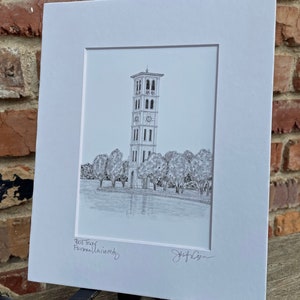 May include: A black and white pencil drawing of the Bell Tower at Furman University. The drawing shows the tower with a clock face and surrounded by trees. The text "Bell Tower Furman University" is written below the drawing, and the artist's signature is in the bottom right corner.