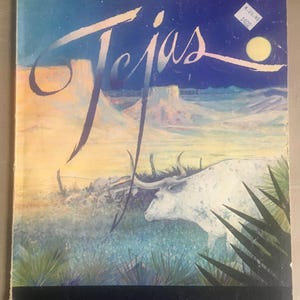 May include: A vintage vinyl record album cover featuring a blue sky with a white moon, a desert landscape with a white bull, and the text "ZZ Top Tejas Words and Music".