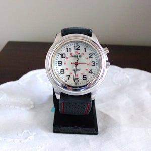 Men's Embassy Wristwatch  Silvertone, New Black Band, w/Light, Max Wrist 8 1/2"
