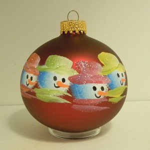 Hand painted snowman family of four on glass christmas ornament