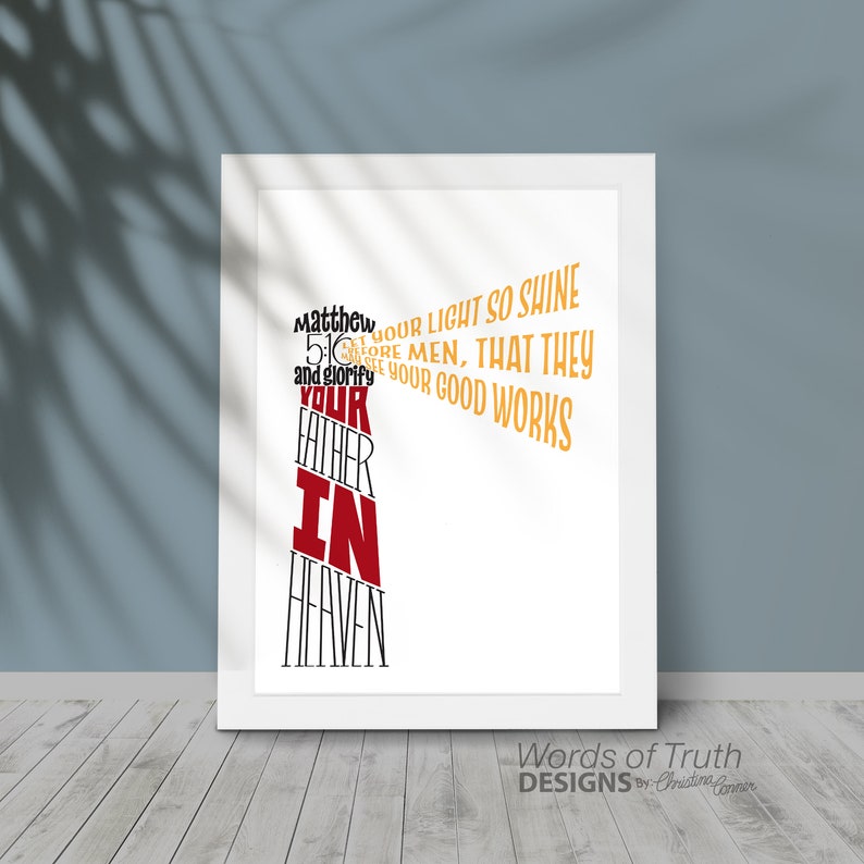 May include: A white framed print with a black and red typography design that reads "Matthew 5:16 Let your light so shine before men, that they may see your good works and glorify your Father in Heaven." The print also includes the text "Words of Truth Designs by Christine Conner".