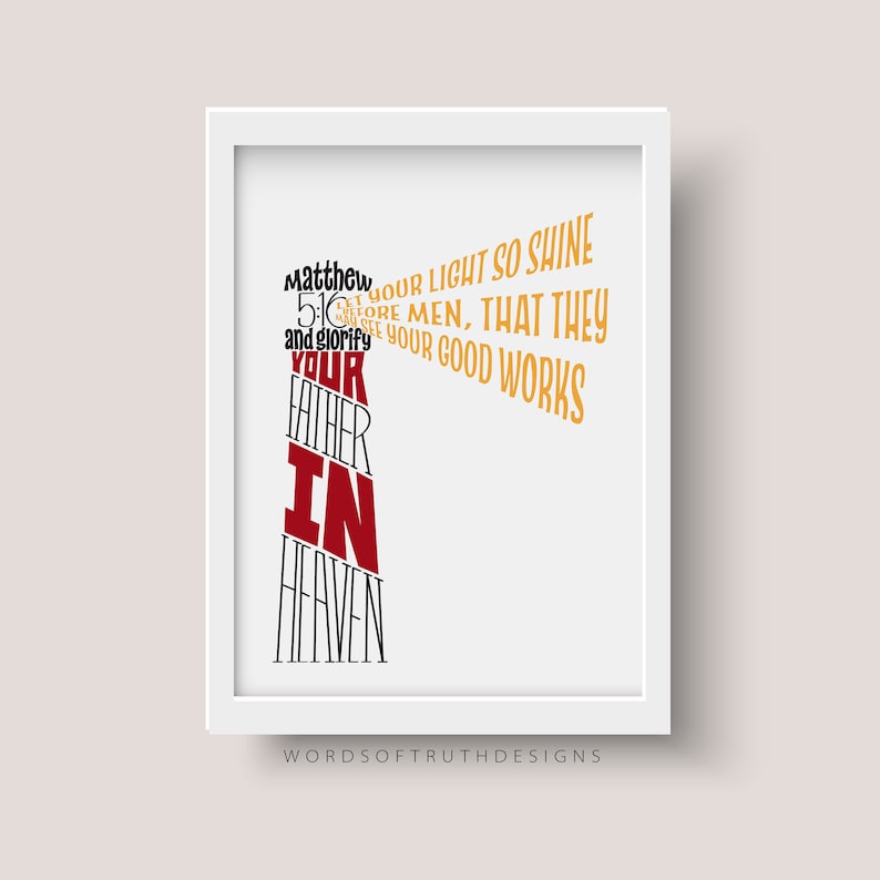 May include: A white framed print with a red and gold typography design. The text reads "Let your light so shine before men, that they may see your good works and glorify your Father in Heaven."  Matthew 5:16. The print is signed "Words of Truth Designs".