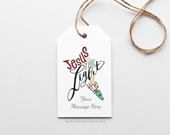 May include: White gift tag with a red, green, and gold design that says "Jesus is the Light of the World". The tag has a space for a message and the words "Words of Truth Designs" at the bottom.