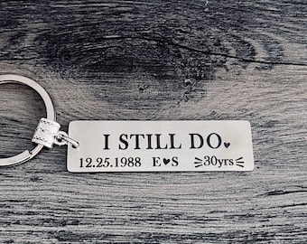 May include: Silver keychain with a rectangular tag that reads "I Still Do. 12.25.1988 E♥S =30yrs=".