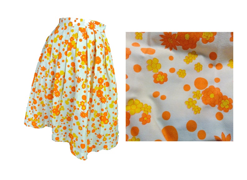 May include: A white skirt with a floral print in orange and yellow. The skirt has a pleated design and a scalloped hem.