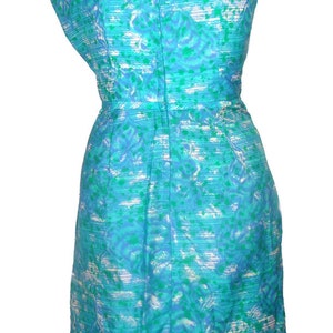 May include: A sleeveless dress with a blue and green floral pattern. The dress has a fitted bodice and a slightly flared skirt.
