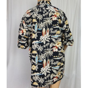 May include: A black short-sleeved button-down shirt with a tropical print featuring palm trees, flowers, and surfboards.