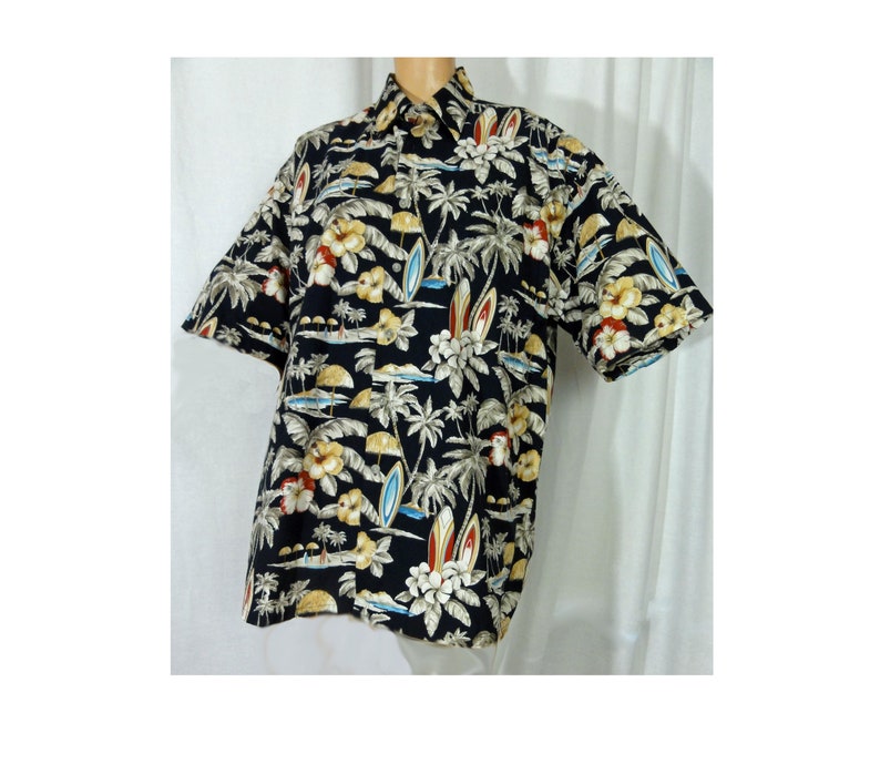 May include: A black short-sleeved button-down shirt with a tropical print featuring palm trees, surfboards, and flowers.