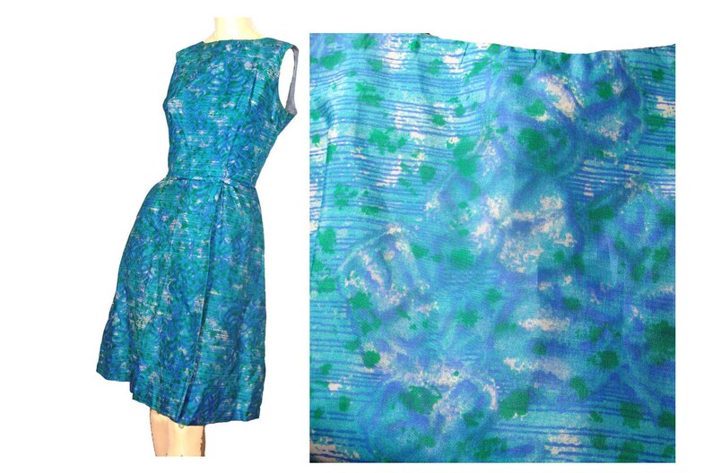 May include: A sleeveless blue dress with a white and green abstract print. The dress has a fitted bodice and a full skirt.