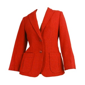 May include: A red blazer with two pockets and a button closure.