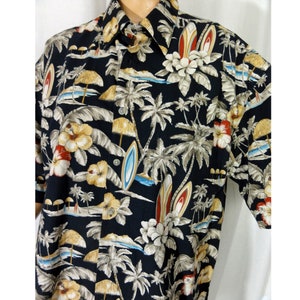 May include: A black short-sleeved button-down shirt with a tropical print featuring palm trees, flowers, and surfboards.