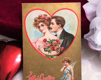 Romantic Antique Valentine’s Day Postcard Edwardian Couple in Heart & Cupid Cherub on Gold Background 1910 Vintage Post Card