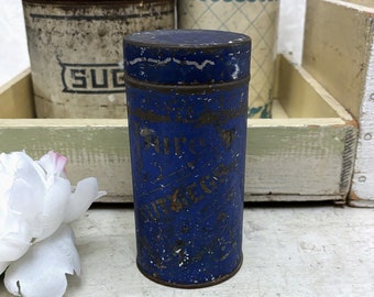 May include: A vintage blue metal tin with gold lettering that reads "BUTTER" and "ECGS". The tin is slightly dented and has a worn, aged appearance.