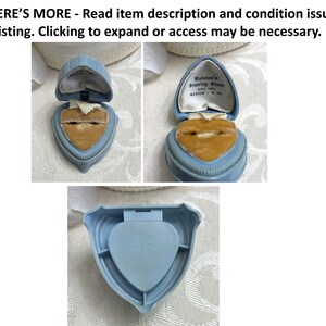 May include: A blue heart-shaped ring box with a velvet interior. The box is open and the lid has the text "Kalston's Jewelry Store" and "Weston, W.Va."