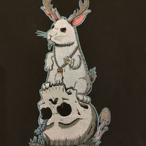 Jackalope Graphic T-shirt: Lucky Paw Charm, Next Level Cotton