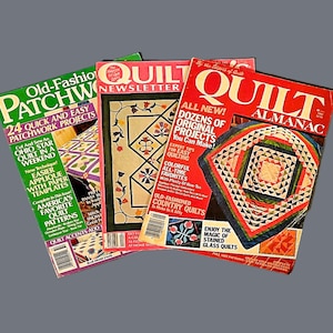 May include: Three quilting magazines with colorful covers featuring patchwork quilt designs. The magazines are titled "Quilt Newsletter", "Quilt Almanac", and "Old-Fashion Patchwork".