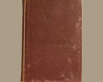 May include: A vintage, maroon-colored hardcover book with a worn, textured cover. The book has a gold-colored spine and edges.