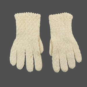 May include: A pair of white crocheted gloves. The gloves have a delicate, lacy pattern.