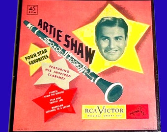 May include: A red, white, and yellow box with a star design. The box features a photo of a man with a clarinet and the text "Artie Shaw Four Star Favorites Featuring His Inspired Clarinet". The box also includes the text "RCA Victor Musical Smart Set".