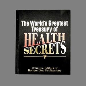 May include: A hardcover book titled "The World's Greatest Treasury of HEALTH SECRETS" on a black background. The title is in white and gold lettering with a red accent. The book is from the Editors of Bottom Line Publications.