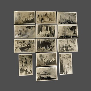 May include: A collection of 14 vintage black and white postcards featuring various views of a cave with stalactites and stalagmites.