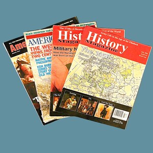 May include: A stack of four magazines, including "American History" and "History" magazines. The top magazine is "History" with the text "The 1450s: When War and Culture Transformed Europe" on the cover. The magazines are all red and white with a map on the cover.