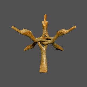 May include: A handcrafted, wooden sculpture with a unique, abstract design. The sculpture features a central vertical support with multiple arms extending outwards. The wood has a natural, aged appearance with a warm, earthy tone.