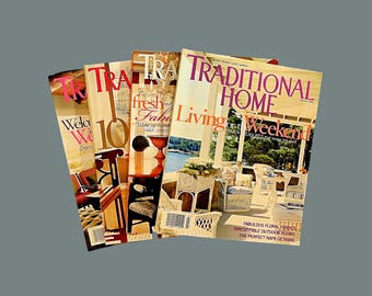 May include: A stack of four magazines with the title "TRADITIONAL HOME" on the top magazine. The magazine covers feature images of a porch, a room with a fireplace, and a room with a window. The text on the covers includes "Living for the Weekend" and "Fresh and Fab".