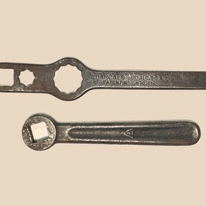 May include: Two vintage metal wrenches. The top wrench has a square and a 12-point socket. The bottom wrench has a square socket. The top wrench is labeled "BARCALO BUFFALO U.S.A. PATENT NO. 1,870,612".
