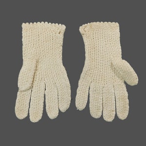 May include: A pair of white crocheted gloves. The gloves have a delicate, lacy pattern and are made of a soft, lightweight yarn.