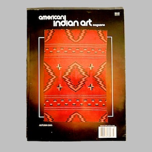 May include: A magazine cover for "American Indian Art" magazine, featuring a red and black geometric pattern on the cover. The magazine is from Autumn 2003.