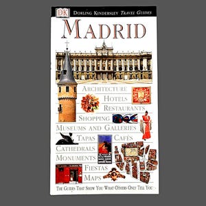 May include: A travel guide titled "Madrid" by Dorling Kindersley. The cover features a collage of images including architecture, a tower, and a woman in a red dress. Text highlights topics like hotels, restaurants, and museums.