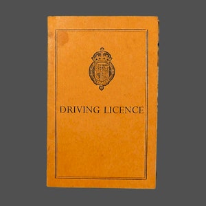 May include: A vintage orange driving license with a black and white royal crest and the text "DRIVING LICENCE".