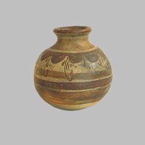May include: A small, round, brown pottery vase with a narrow neck and a decorative pattern of brown and white stripes and swirls.