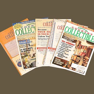 May include: A collection of five American Country Collectibles magazines. The magazines feature articles about collecting, decorating, and finding treasures. The covers feature a variety of items, including antique furniture, vintage toys, and old books.