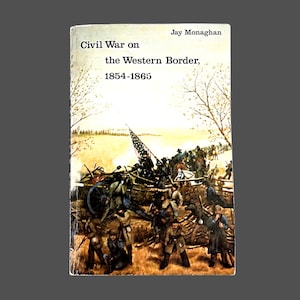 May include: A book titled "Civil War on the Western Border, 1854-1865" by Jay Monaghan. The cover features a historical illustration of soldiers in battle with a cannon and American flag.