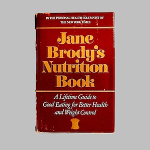 May include: A red hardcover book titled "Jane Brody's Nutrition Book: A Lifetime Guide to Good Eating for Better Health and Weight Control" by the personal health columnist of The New York Times.