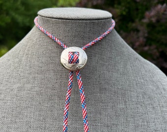 Classic Americana Concho Slider Bolo Tie Necklace with Dangling Arrow tips and patriotic flag print cord