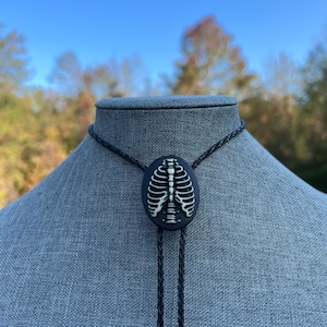 Gothic Skeleton Rib Cage Bolo Tie Necklace Black Braided Faux Leather Cord Metal Tips Rockabilly Goth Punk Retro Unisex Jewelry Halloween