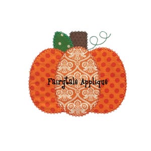 May include: A patchwork pumpkin applique with orange, white, and green fabric. The pumpkin has a brown stem and the text "Fairytale Applique" is stitched on the front.