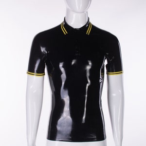 May include: A black latex polo shirt with yellow trim on the collar and sleeves. The shirt is on a white mannequin.