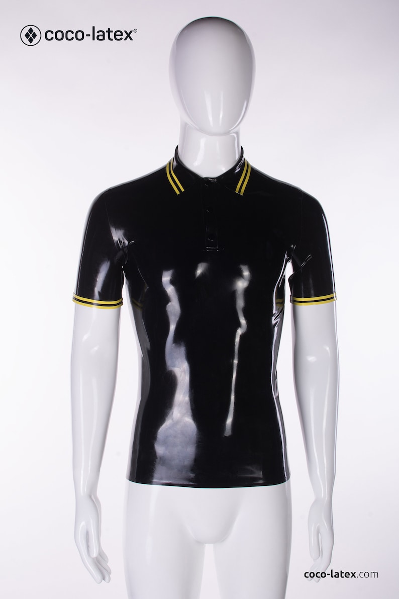 May include: A black latex polo shirt with yellow trim on the collar and sleeves. The shirt is on a white mannequin.