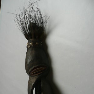 Papua New Guinea Sepik ancestor figure with cowrie shell and feather decorations