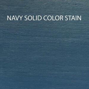 May include: A close-up of a dark blue wooden surface stained with a solid color. The text "NAVY SOLID COLOR STAIN" is printed in white on the surface.