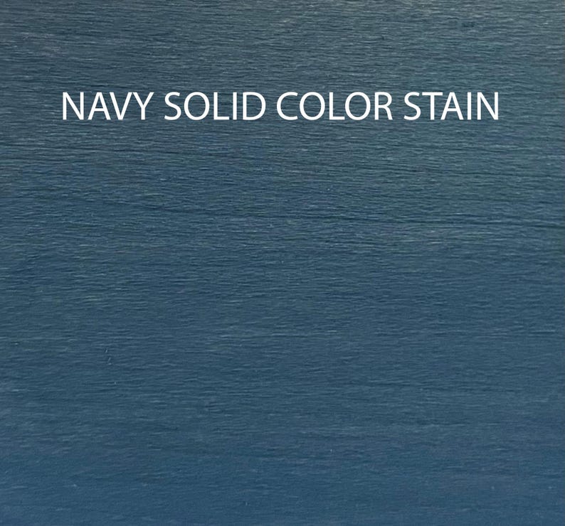 May include: A close-up of a dark blue wooden surface stained with a solid color. The text "NAVY SOLID COLOR STAIN" is printed in white on the surface.