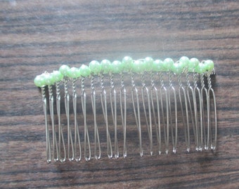 silver plated hair comb with green shell pearls.