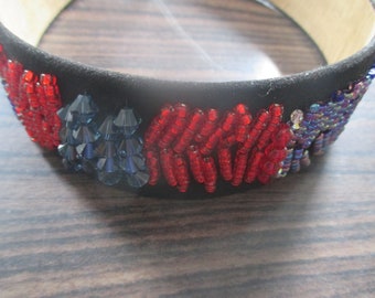 Black hair band with hand sewn seed beads and swarovski .