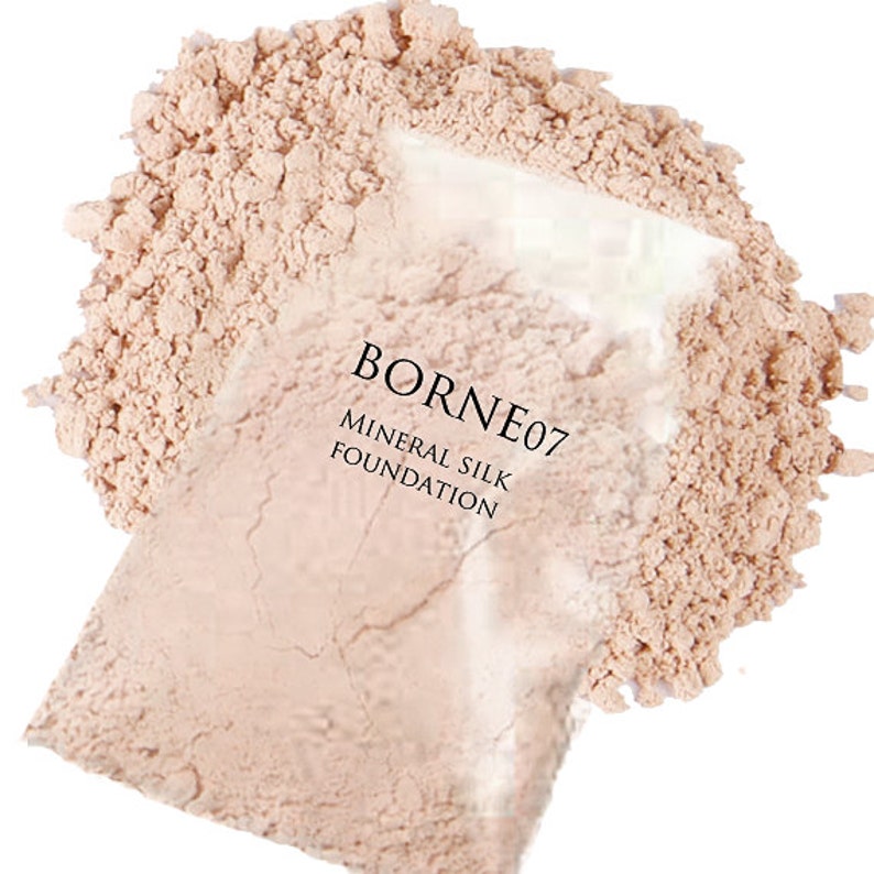 May include: A close-up of a light beige mineral silk foundation powder in a clear plastic bag. The bag has the text "BORNEO7 MINERAL SILK FOUNDATION" printed on it.