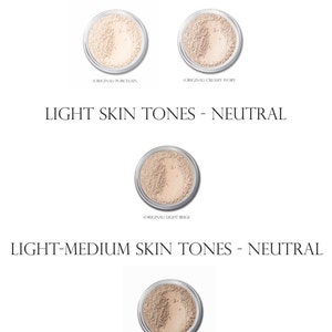 May include: Four shades of foundation powder in small round containers. The shades are labeled "Original Porcelain", "Original Creamy Ivory", "Original Light Beige", and "Original Medium Light Beige".